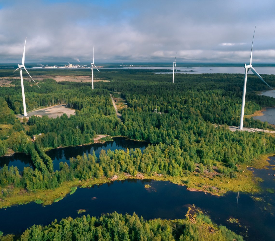 Wind turbines in a forest with lakes