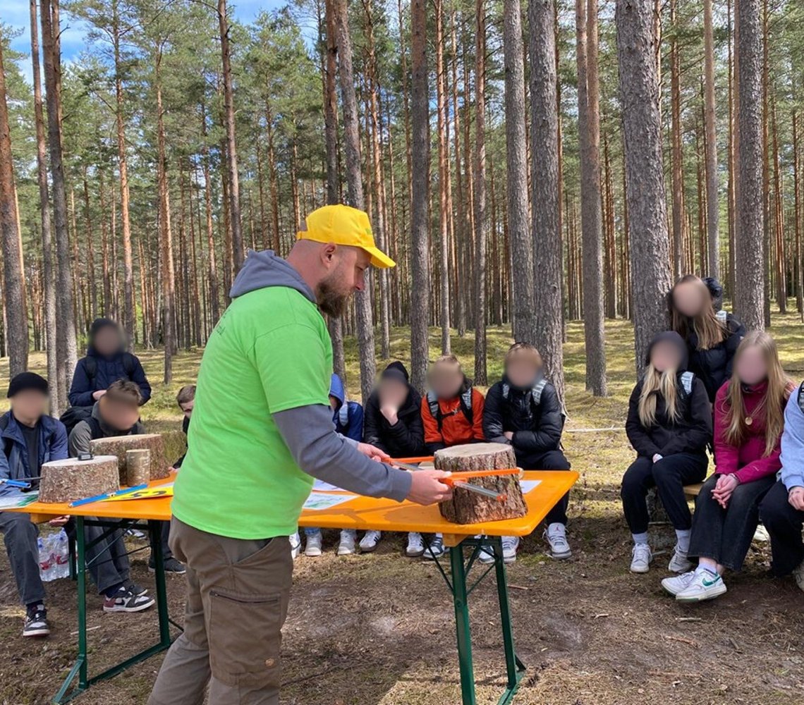 Forester presenting to children with blurred out faces for privacy