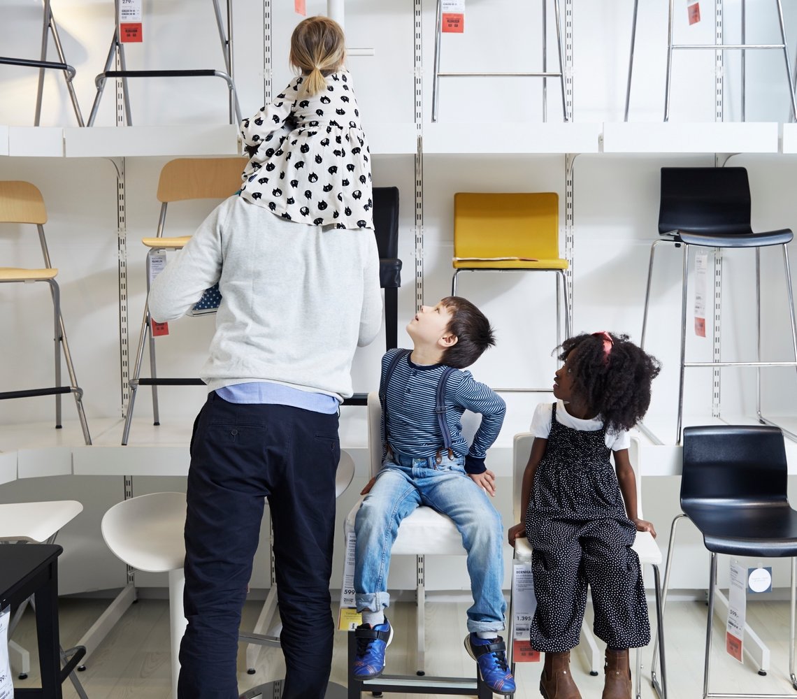Family testing out different chairs in the IKEA wearhouse.