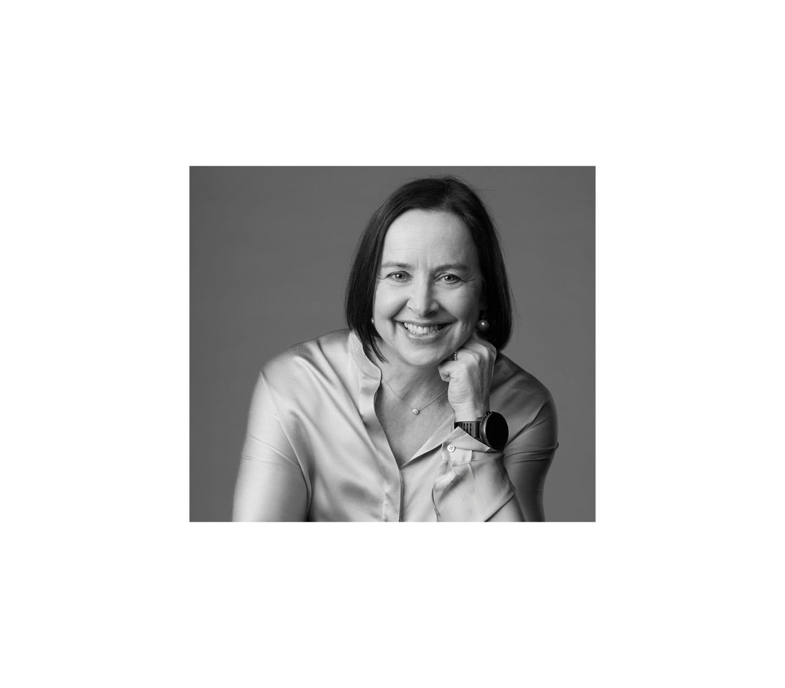 A black and white portrait of Karen Pflug smiling to the camera.
