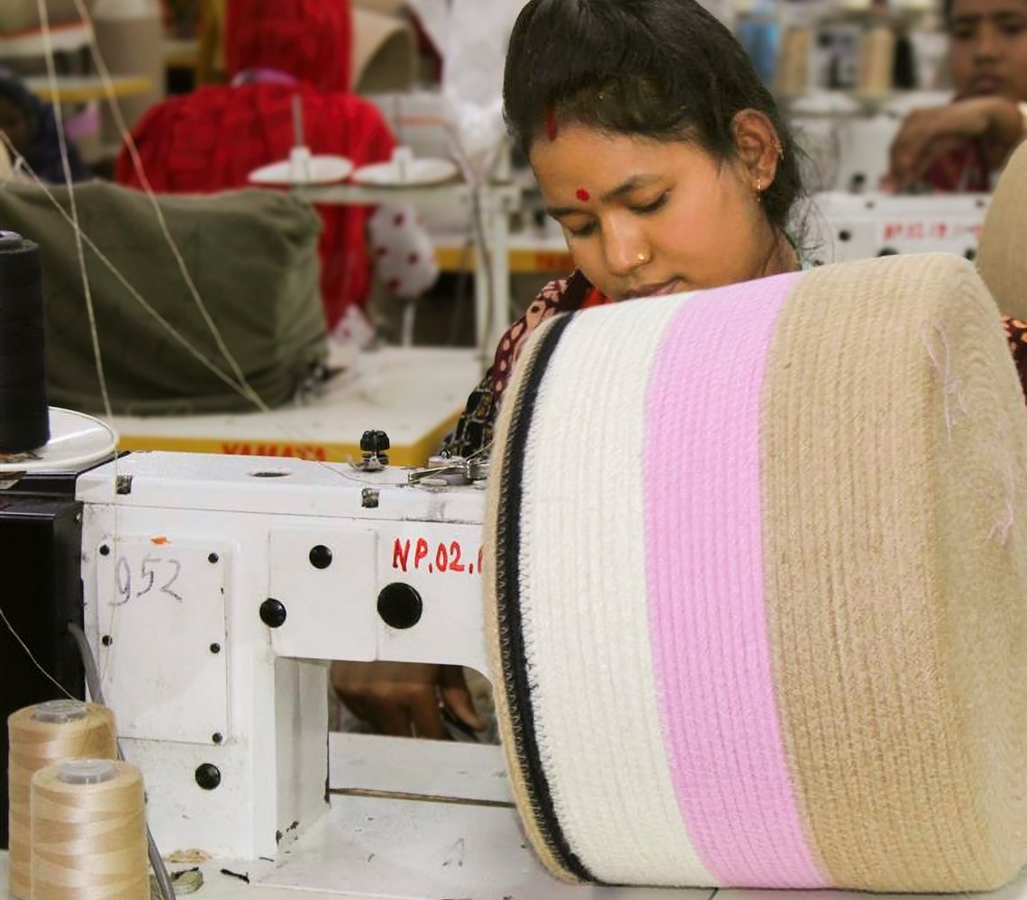 Woman sewing textiles at IKEA supplier factory.