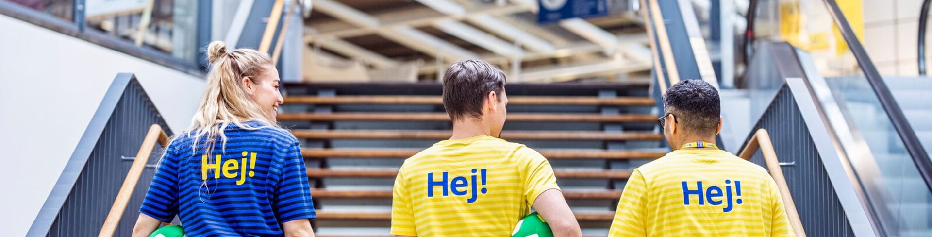 Co-workers walking up the stairs in an IKEA store.