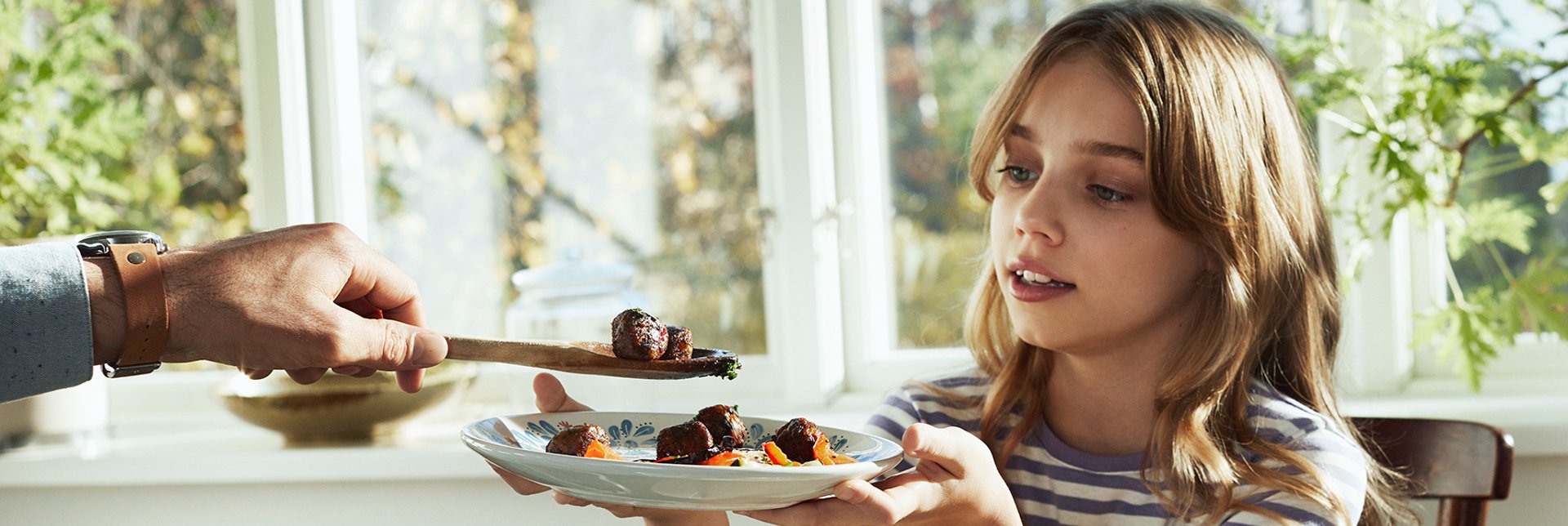 Child being served a vegetarian meal.