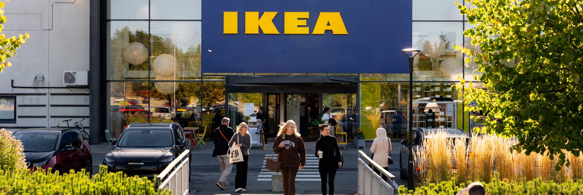 External view of customers leaving an IKEA shop via the front entrance.
