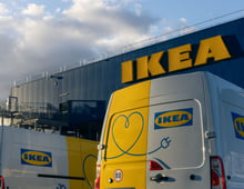 Electric vans parked in front of an IKEA store.