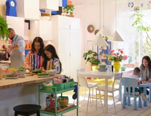 Family cooking and dining in a colorful kitchen.
