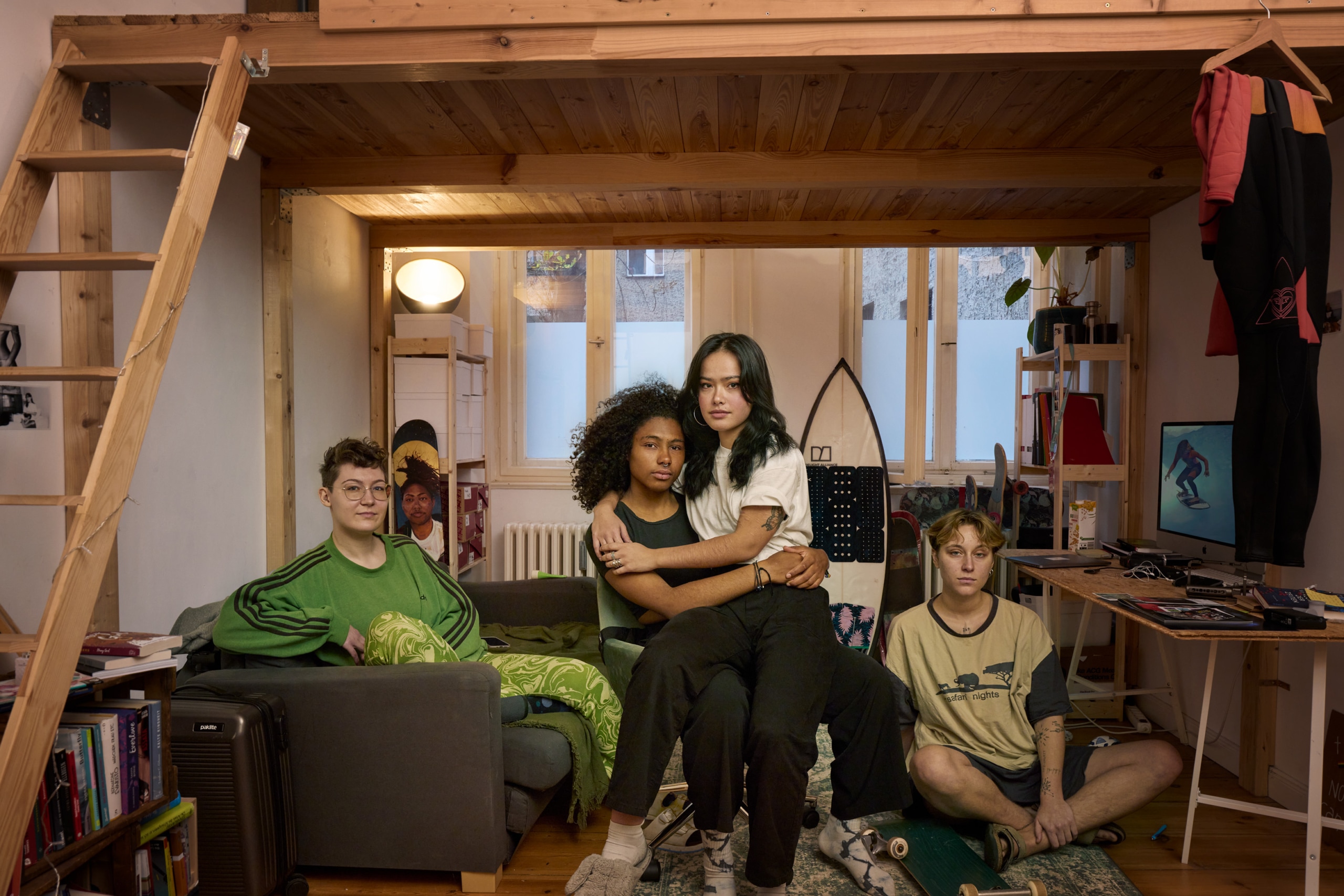 Maria and her friends sitting underneath a loft bed.