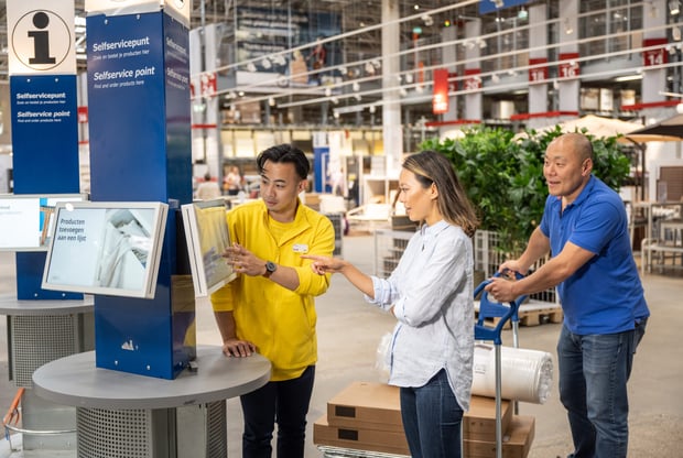 Customers receiving help from an IKEA staff member