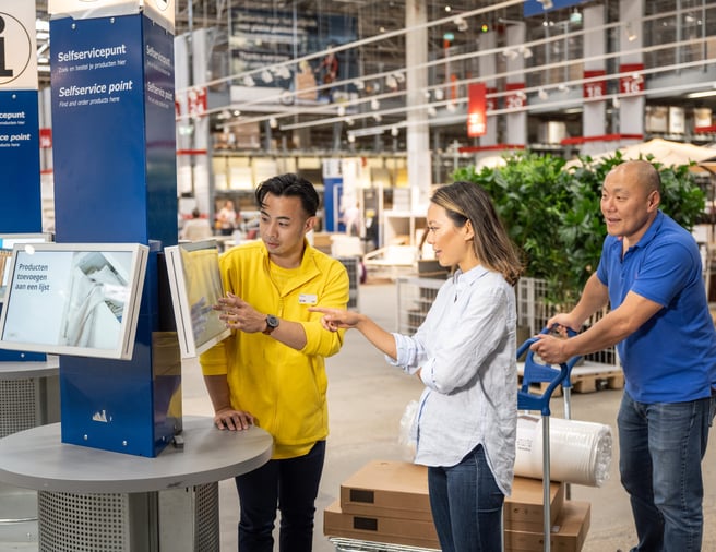 Customers receiving help from an IKEA staff member