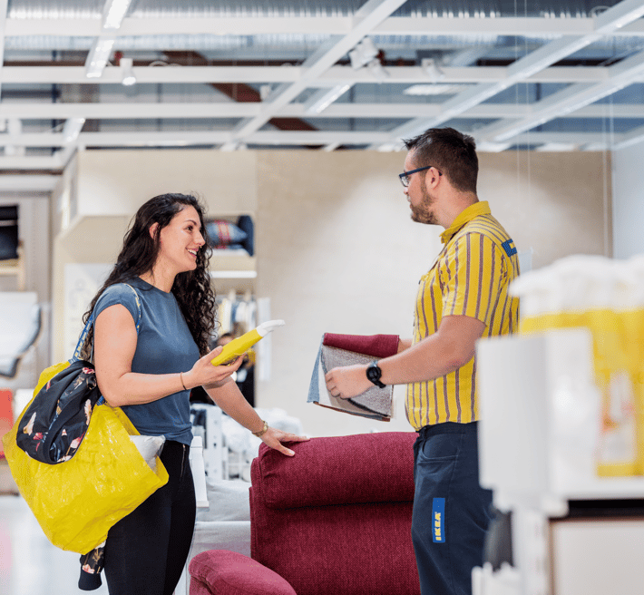 IKEA co-worker helping customer in store.