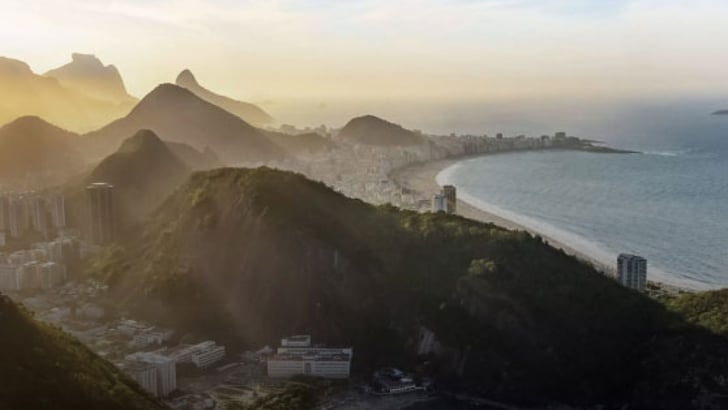 The sun is setting over a coastline