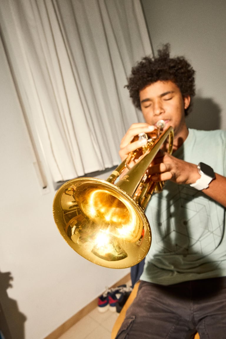 A young man plays the trumpet.