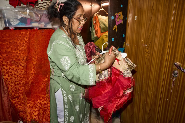 A woman hanging clothes on a hanger.