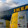 alttext Electric vans parked in front of an IKEA store.