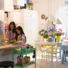 alttext Family cooking and dining in a colorful kitchen.