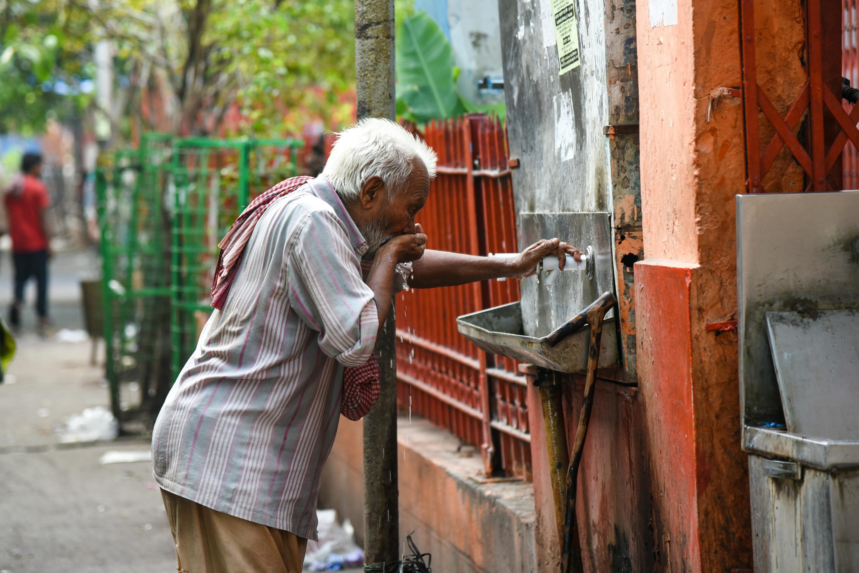 Man drinking water from fountain