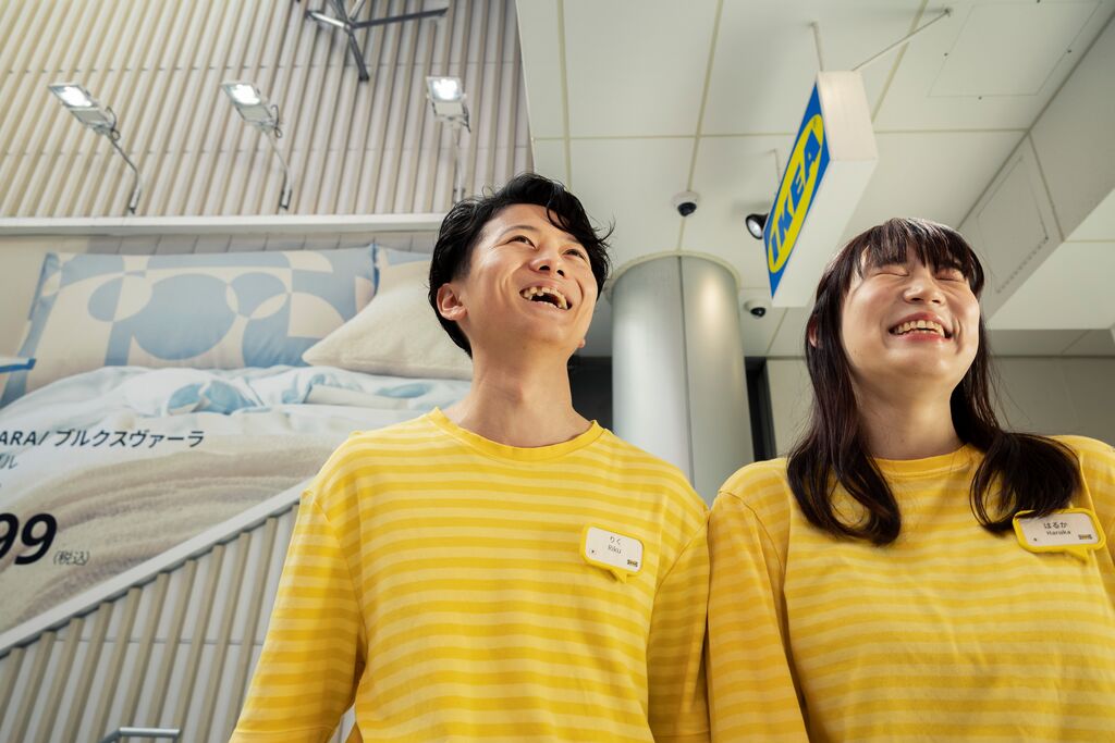 Two IKEA co-workers laughing in the store.